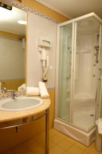 a bathroom with a sink and a shower at Hotel Futura Centro Congressi in Naples