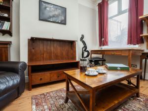 a living room with a coffee table and a couch at Pass the Keys Spacious and Comfortable 3 Bed Home in Birkenhead in Birkenhead