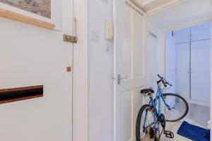 a blue bike parked in a room with a door at Central 1BD Flat 6 minutes to Old Street station in London