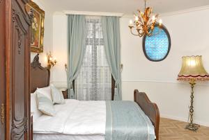 a bedroom with a bed and a window at Royal Hotel in Varna City