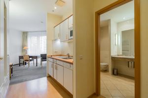 a kitchen with a sink and a dining room at Apartmenthaus Berlin Mitte in Berlin +134 photos
