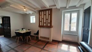 a dining room with a table and chairs and a window at Appart central Vatan-2 chb- wifi in Vatan +17 photos