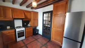 a kitchen with wooden cabinets and a white stove top oven at Appart central Vatan-2 chb- wifi in Vatan