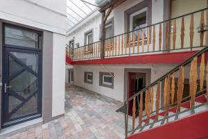 an empty hallway of a building with a balcony at Coeur de Ville - gare à 200m in Saverne +5 photos