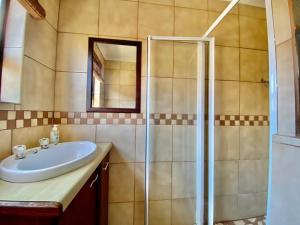 a bathroom with a sink and a shower at Seaside Haven in Pearly Beach +6 photos
