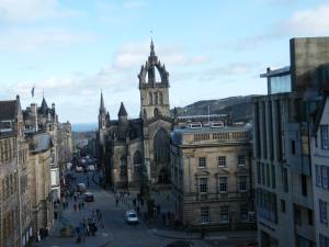 an old building with a clock tower in a city at Royal Mile Group Apartments in Edinburgh