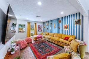a living room with a couch and a table at Friends-Themed 4BD - Pingpong & Outdoor Theater in Houston