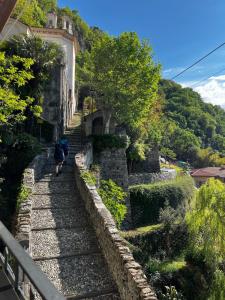 a group of people walking down a stone stairs at Postcard view 3 minutes walk from the lake in Menaggio