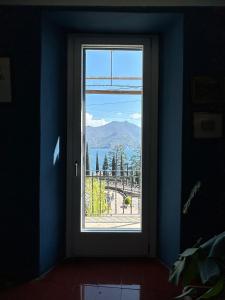 a window in a room with a view of a mountain at Postcard view 3 minutes walk from the lake in Menaggio