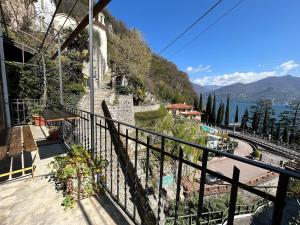 a balcony of a house with a view of the water at Postcard view 3 minutes walk from the lake in Menaggio