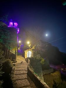 a set of stairs leading up to a building at night at Postcard view 3 minutes walk from the lake in Menaggio