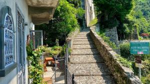 a stone stairway leading up to a building at Postcard view 3 minutes walk from the lake in Menaggio