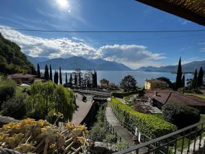 a view of a garden with a view of the water at Postcard view 3 minutes walk from the lake in Menaggio