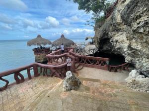 a man is standing on a pier near the ocean at Villa VP One - Punta rucia beach in Punta Rucia