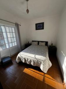 a bedroom with a bed and a wooden floor at Casa Paraíso in Ribeira de Pena
