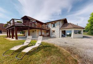 a group of chairs sitting in front of a house at Loft avec jacuzzi et sauna in Ferrières-la-Verrerie