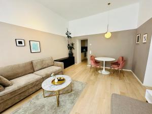 a living room with a couch and a table at Panda Apartment in Vienna +8 photos