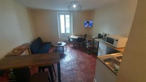 a small kitchen with a table and a microwave at Appart central Vatan-1 chb-wifi in Vatan +5 photos