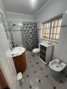 a bathroom with a sink and a toilet and a shower at Casa Paraíso in Ribeira de Pena