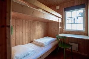 a room with two bunk beds and a green chair at Trysilfjellet Nord 637 in Trysil