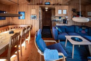 a living room with a blue couch and a table at Trysilfjellet Nord 637 in Trysil