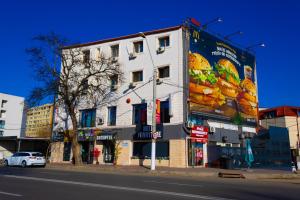 a white building on the side of a street at Hotel Funnytime in Bucharest