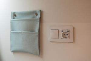 a lightswitch on a wall with a face on it at Das Carretas in Madrid