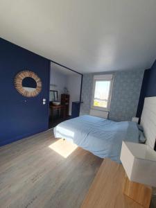 a bedroom with a bed and a mirror on the wall at Duplex appartement 4 chambres120m2 in Grande-Synthe +5 photos