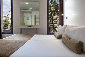 Postel nebo postele na pokoji v ubytování BCN Urbaness Hotels Del Comte + 28 fotografií