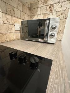 a microwave sitting on top of a counter at 2 Bedroom flat by London Bridge & The Shard in London +9 photos