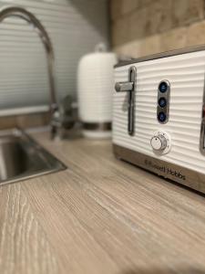 a toaster on a kitchen counter with a sink at 2 Bedroom flat by London Bridge & The Shard in London