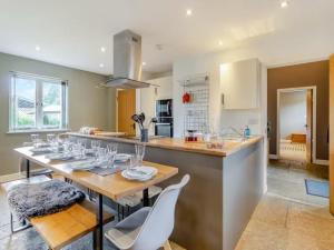 a kitchen with a table with wine glasses on it at Beautiful Stone Barn with Hot Tub on a Quiet Farm in Eckington
