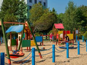 a group of children playing in a playground at Novotel Gdańsk Marina in Gdańsk