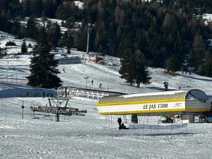 a yellow building on a snow covered ski slope at Appartement T2 Superdévoluy - Les Chaumettes in Le Dévoluy