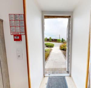 a door to a hallway with a view of a walkway at Studio Poudrière in Ferrières-la-Verrerie +3 photos