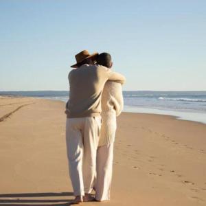 a man and a woman standing on the beach at Maranata Suítes in Peruíbe +26 photos