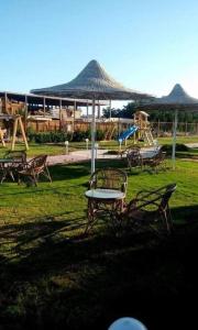 a park with a table and chairs and a playground at Fox Beach Inn in Hurghada