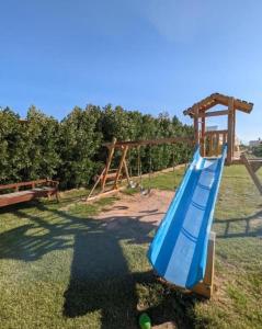 a playground with a blue slide in the grass at Fox Beach Inn in Hurghada