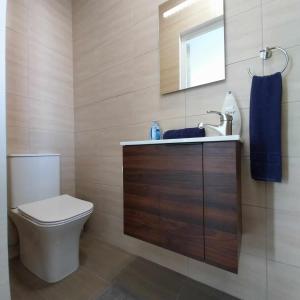 a bathroom with a toilet and a sink and a mirror at Luxury 9 person Holiday Home a walk to Paceville's nightlife in Is-Swieqi +29 photos