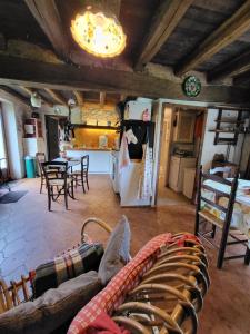a kitchen and a living room with a couch and a refrigerator at Maison de Campagne Les Loges de Brenne in Ardentes