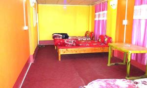 a living room with a couch and a table at MOUNTAIN INN LP Homestay in Kalimpong