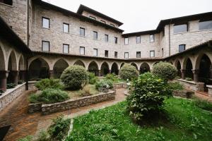 an old building with a garden in front of it at Eremo di Bienno in Bienno