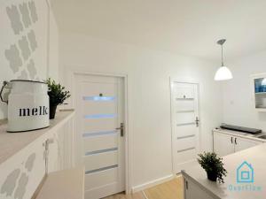 a kitchen with white walls and blue stripes on the door at Danzig Room at Old Town Gdansk in Gdańsk +7 photos
