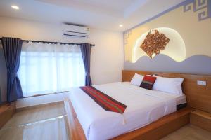 Postel nebo postele na pokoji v ubytování Chenfong Rakthai Resort-ไร่ชาเฉินฟงรีสอร์ท