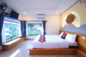 Postel nebo postele na pokoji v ubytování Chenfong Rakthai Resort-ไร่ชาเฉินฟงรีสอร์ท
