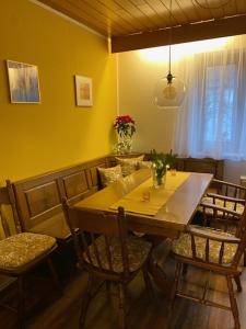 a dining room with a table with chairs and a dining room at Ferienhaus Irene in Friedrichshafen