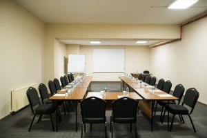 a conference room with tables and chairs and a whiteboard at Monezza Maltepe Rezidans in Istanbul