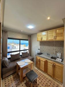 a living room with a couch and a table at Tirazir House 6 in Mirleft