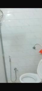 a bathroom with a toilet and a shower at Hotel CBD in Navi Mumbai