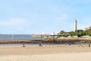 a group of people on a beach with orange cones at Maison charmante à Saint-Georges-de-Didonne avec jardin in Saint-Georges-de-Didonne